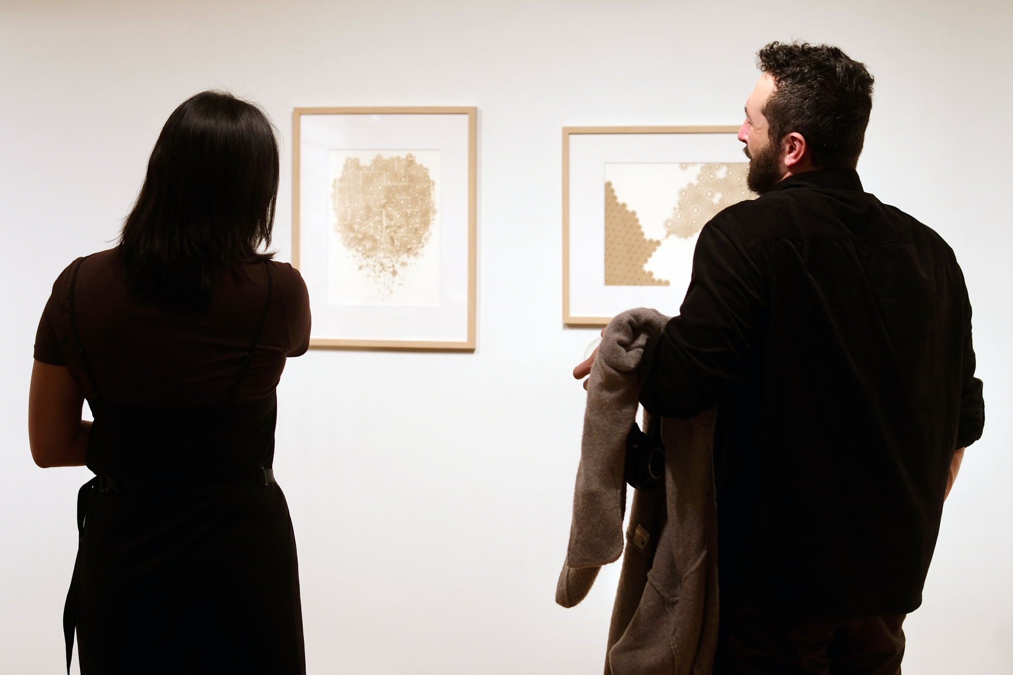 Disintegrating (State of Mind) and Yearning (for a Fantasy) laser engravings displayed on gallery wall