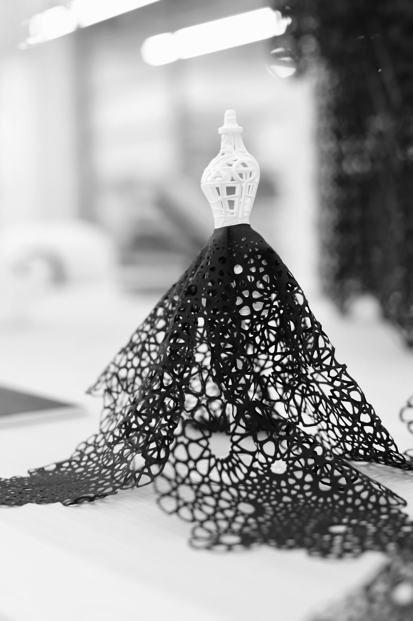 Frontal detail of a black cutwork textile sculpture at Polymaths